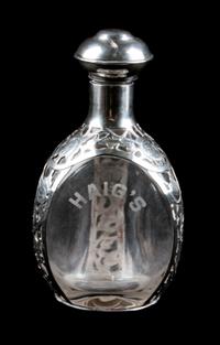 A Mexican Silver Mounted Glass Decanter, , the silver with open overlay work, the bottle etched for Haig whisky.