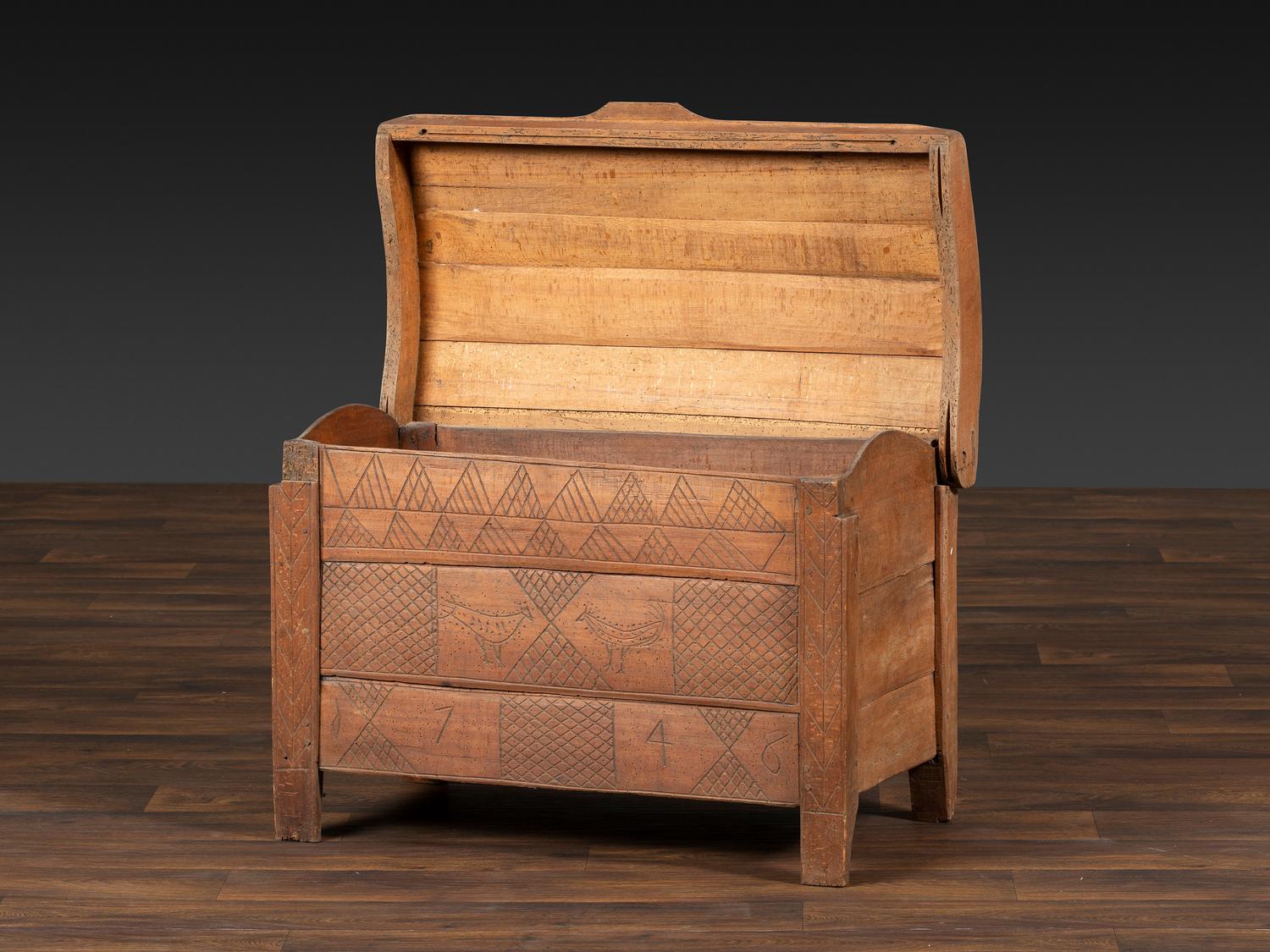 A Continental Chip and Bird Carved Dome-Top Blanket Chest