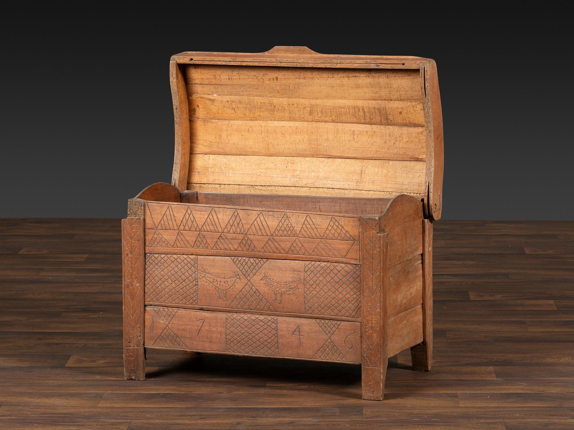 A Continental Chip and Bird Carved Dome-Top Blanket Chest