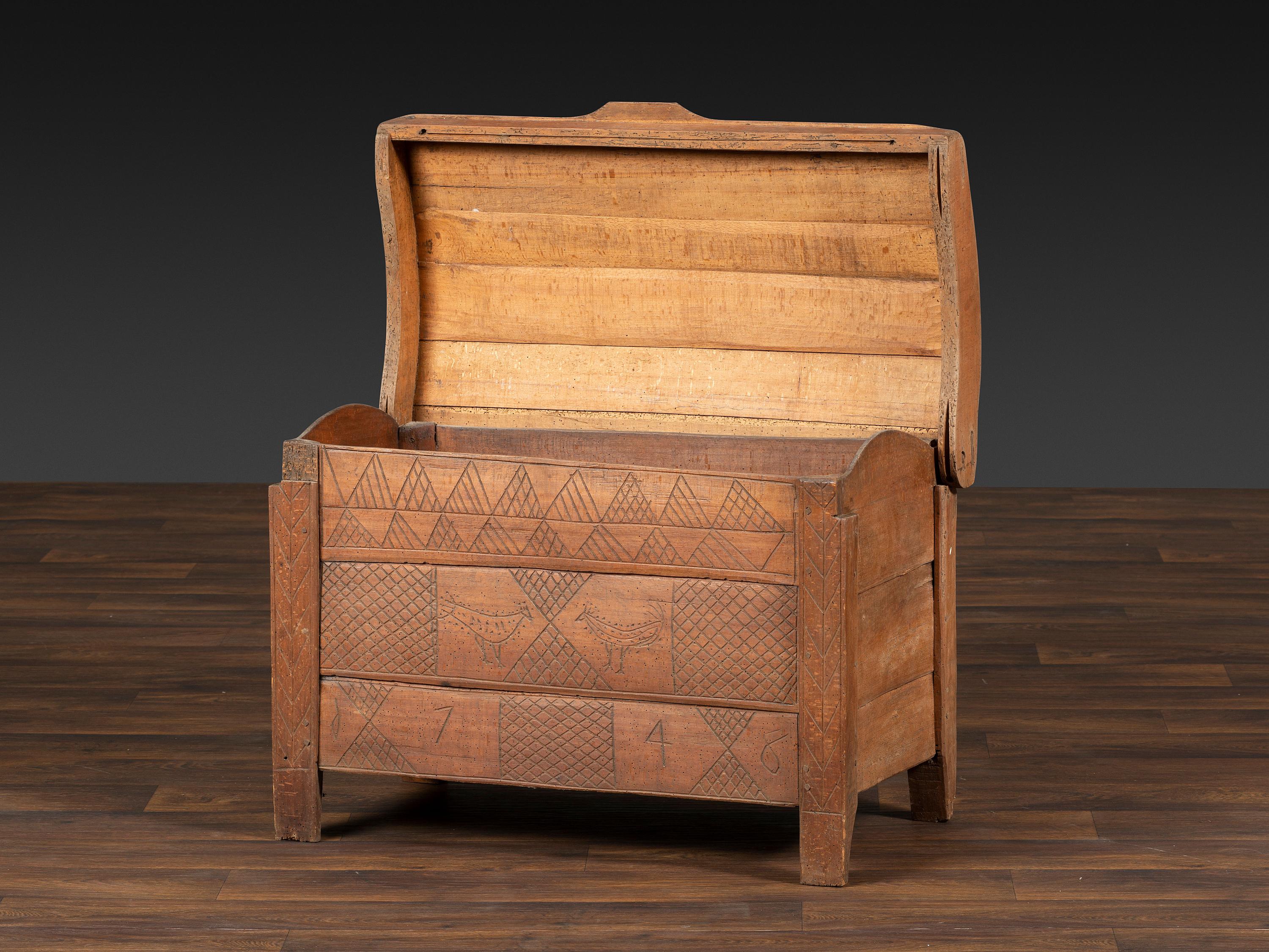 A Continental Chip and Bird Carved Dome-Top Blanket Chest