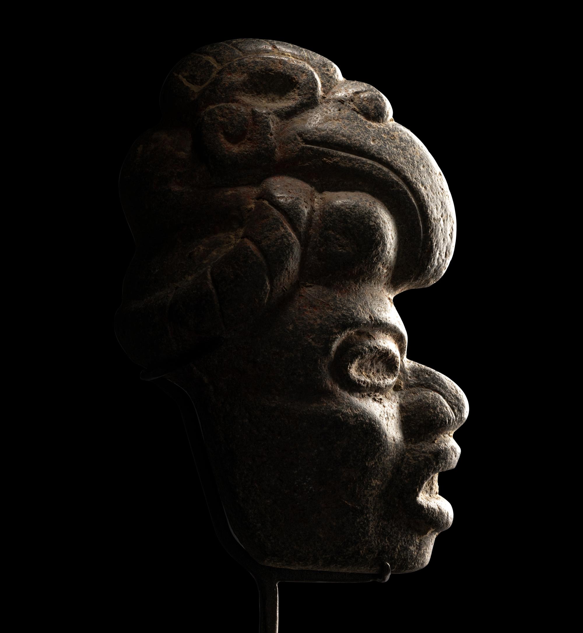 A Maya Stone Hacha of a Warrior Wearing a Helmet in the Form of a Macaw