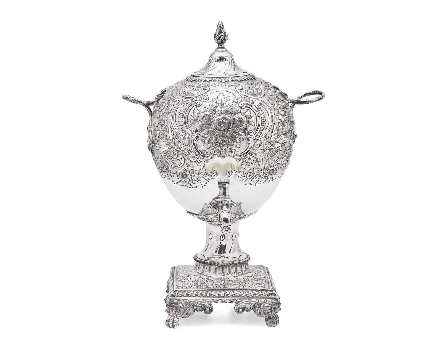 A George III sterling silver floral repoussé hot water urn, maker's mark rubbed, London, 1766