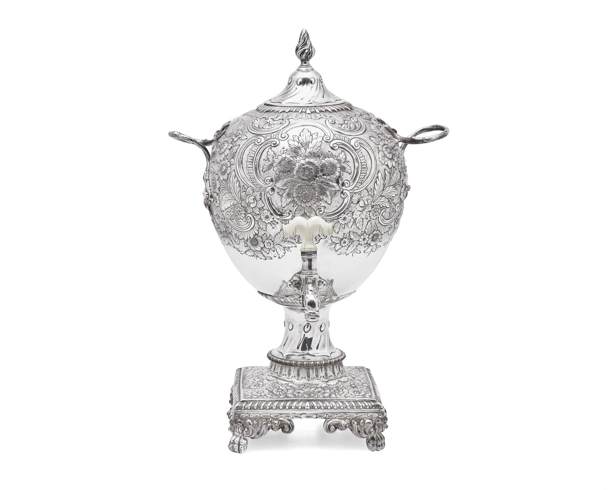 A George III sterling silver floral repoussé hot water urn, maker's mark rubbed, London, 1766