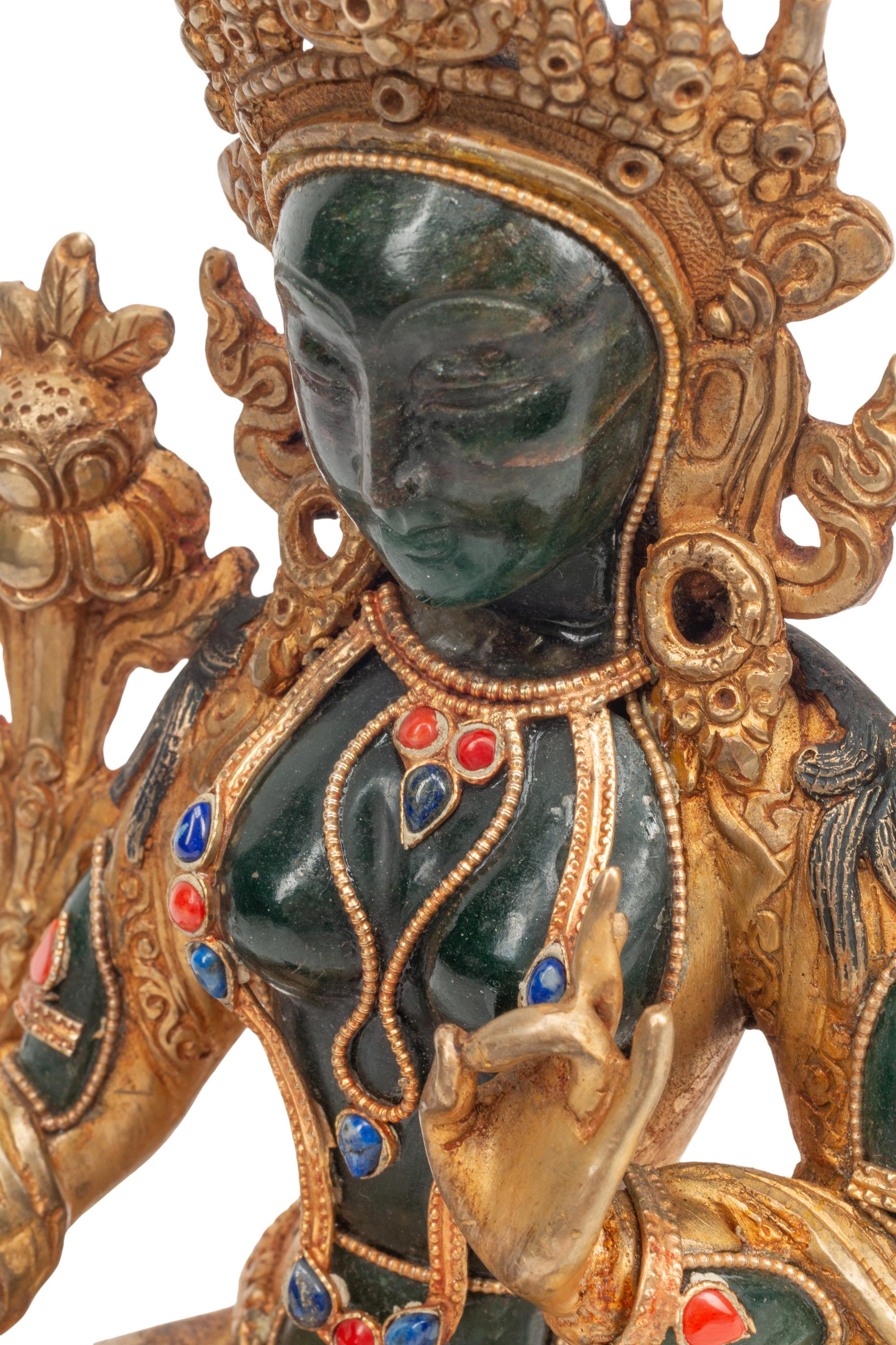 A Southeast Asian Semiprecious Stone-Inset Gilt Bronze Seated Deity