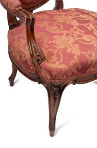 A Pair of Louis XV Style Carved Walnut Fauteuils