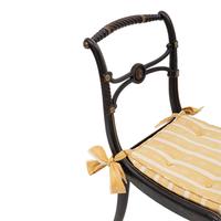 A Suite of Six Regency Ebonized and Caned Dining Chairs
