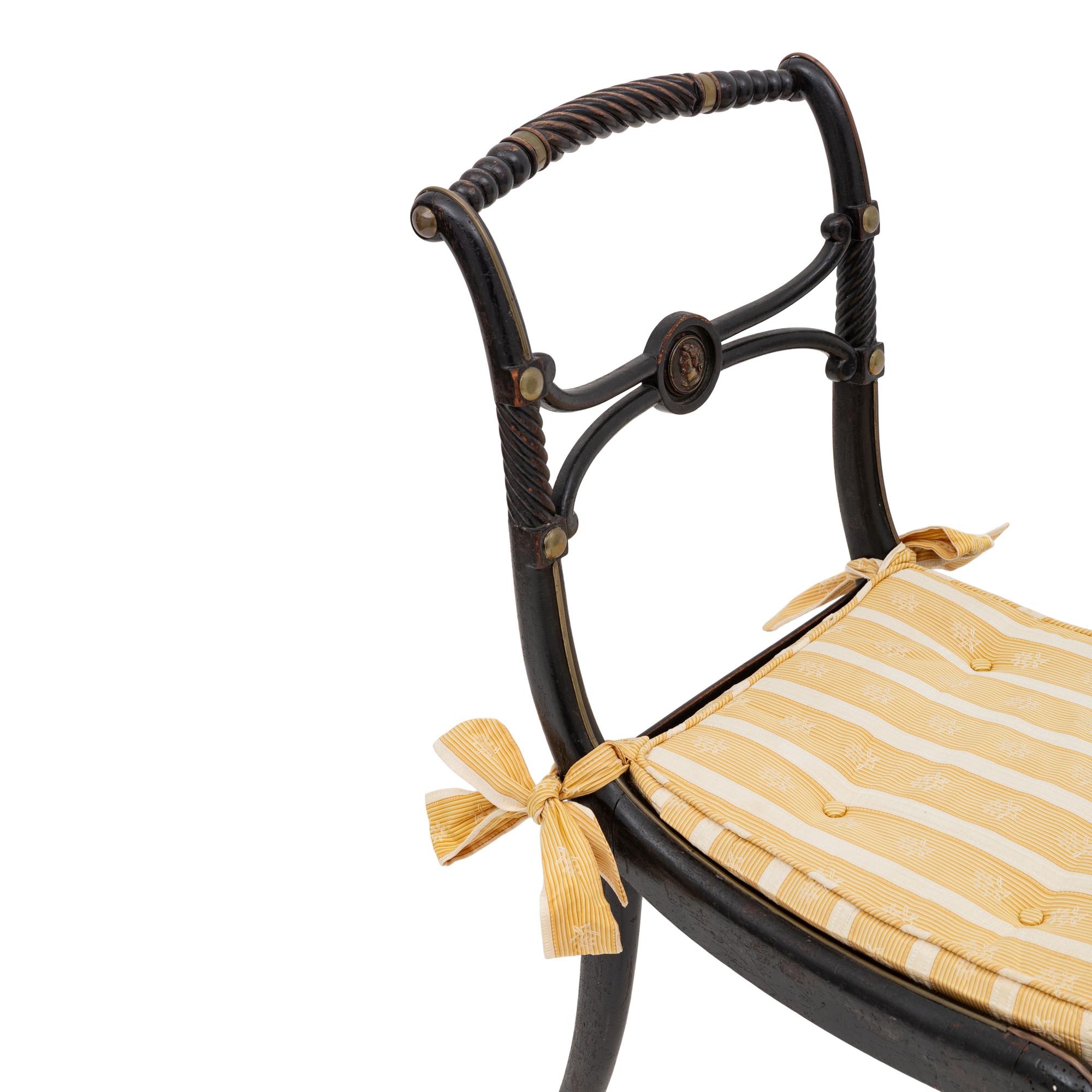 A Suite of Six Regency Ebonized and Caned Dining Chairs