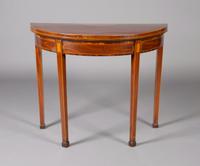 A George III Mahogany and Inlaid Games Table, Height 29 1/8 x width 36 x depth 17 3/4 inches closed.
