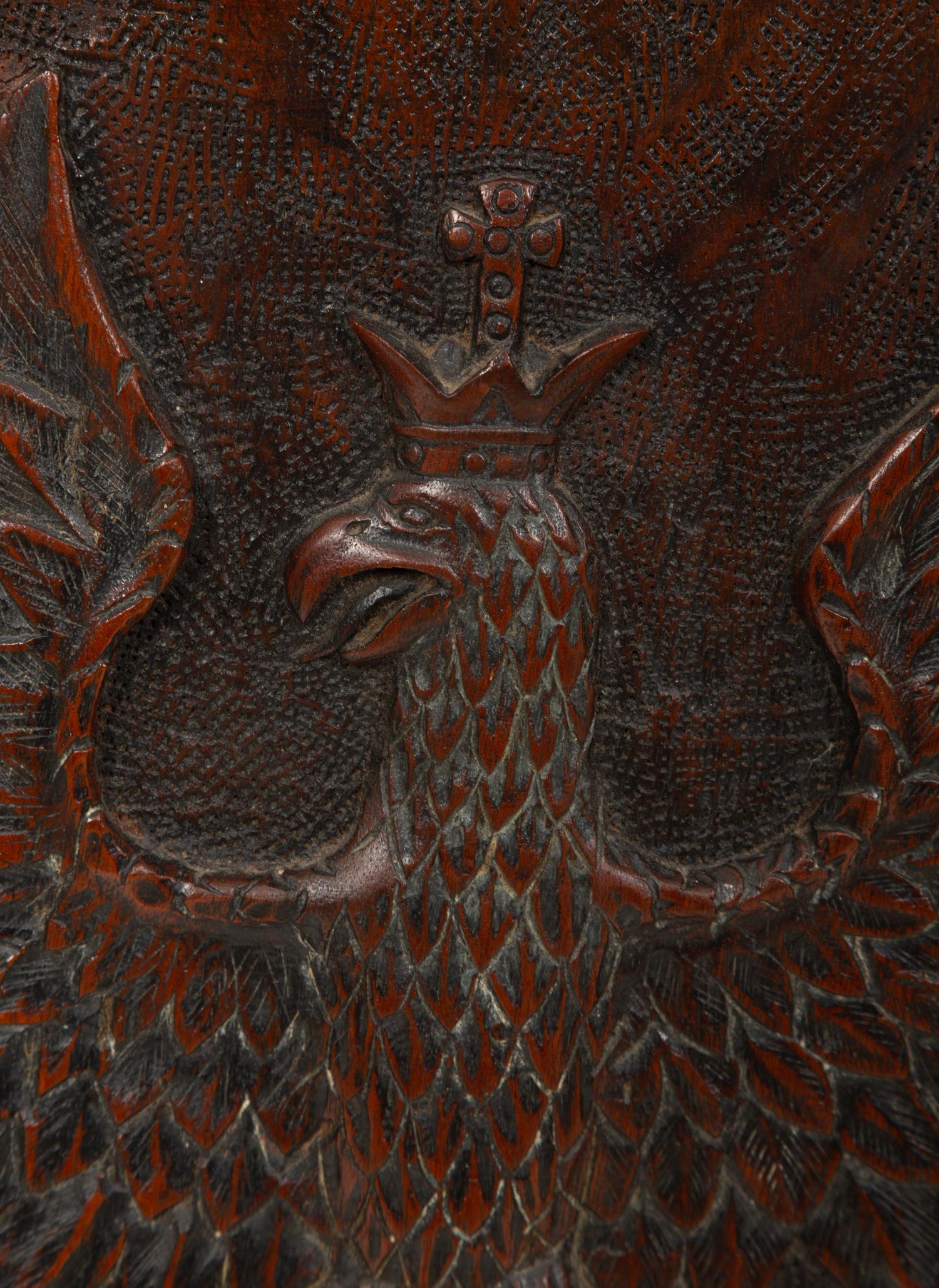 A Continental Carved Wood Panel of Spread Winged Crowned Eagle