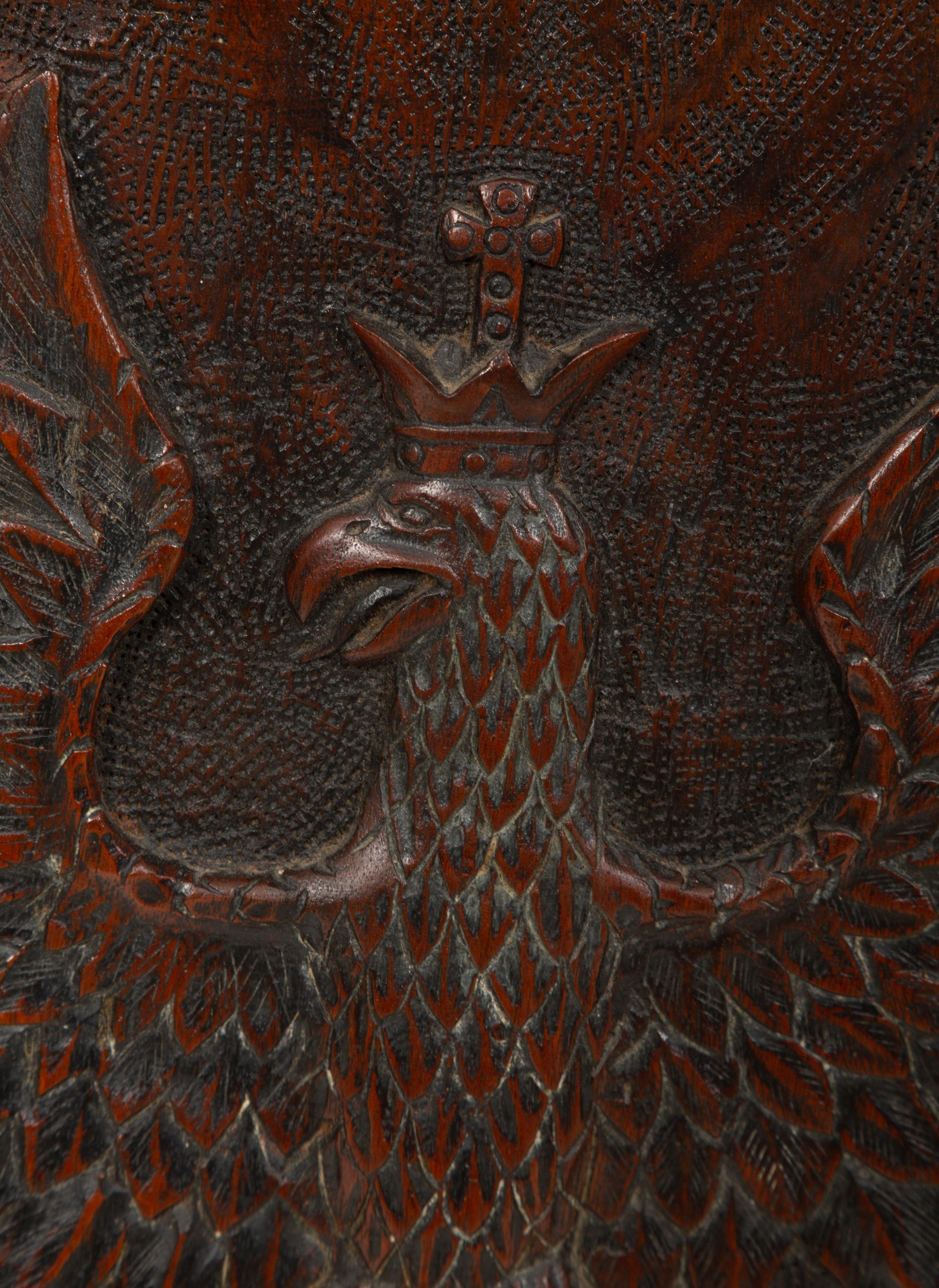 A Continental Carved Wood Panel of Spread Winged Crowned Eagle