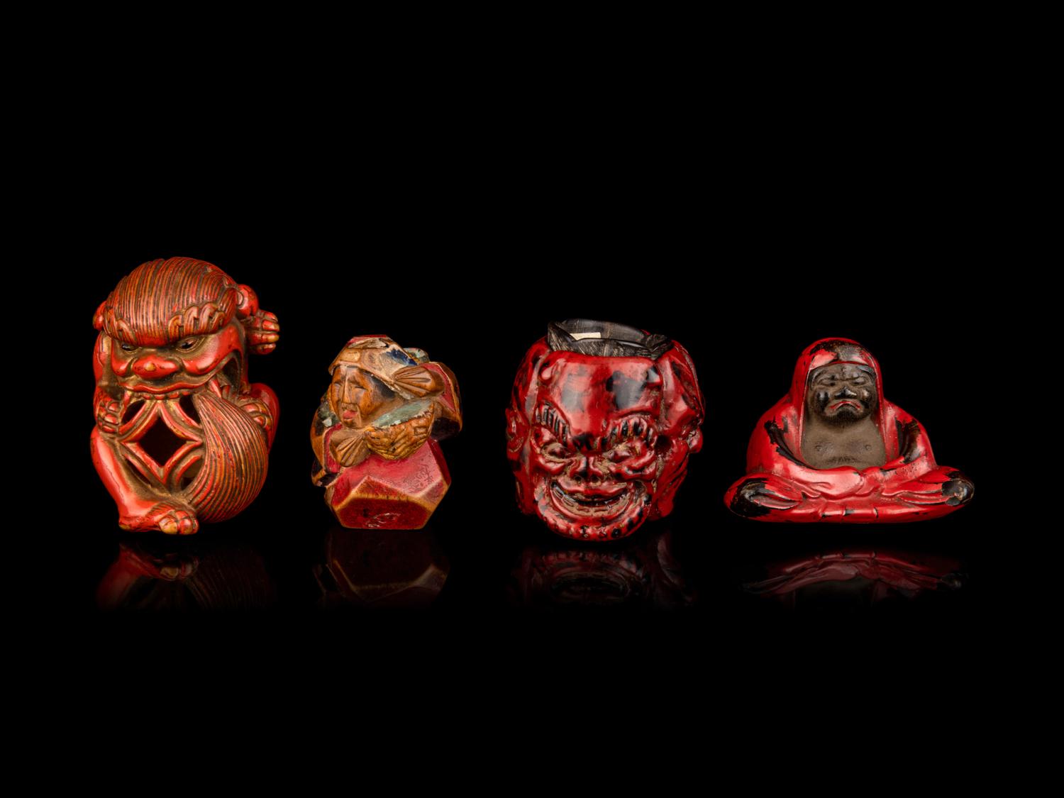 Four Japanese Carved and Red Lacquered Wood Netsuke