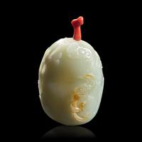 A Chinese Carved Celadon and Russet Jade Snuff Bottle