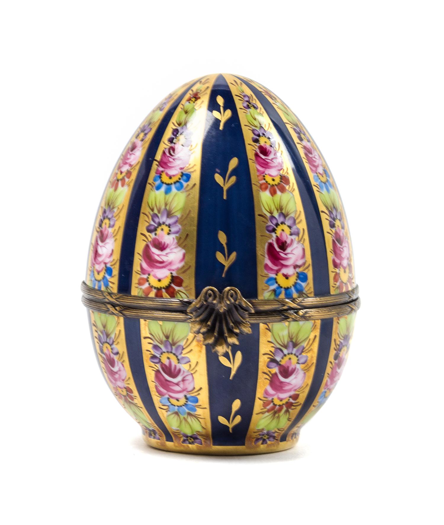 A Limoges Hand Painted Porcelain Egg-Form Box Height 4 3/4 inches. — 20TH CENTURY