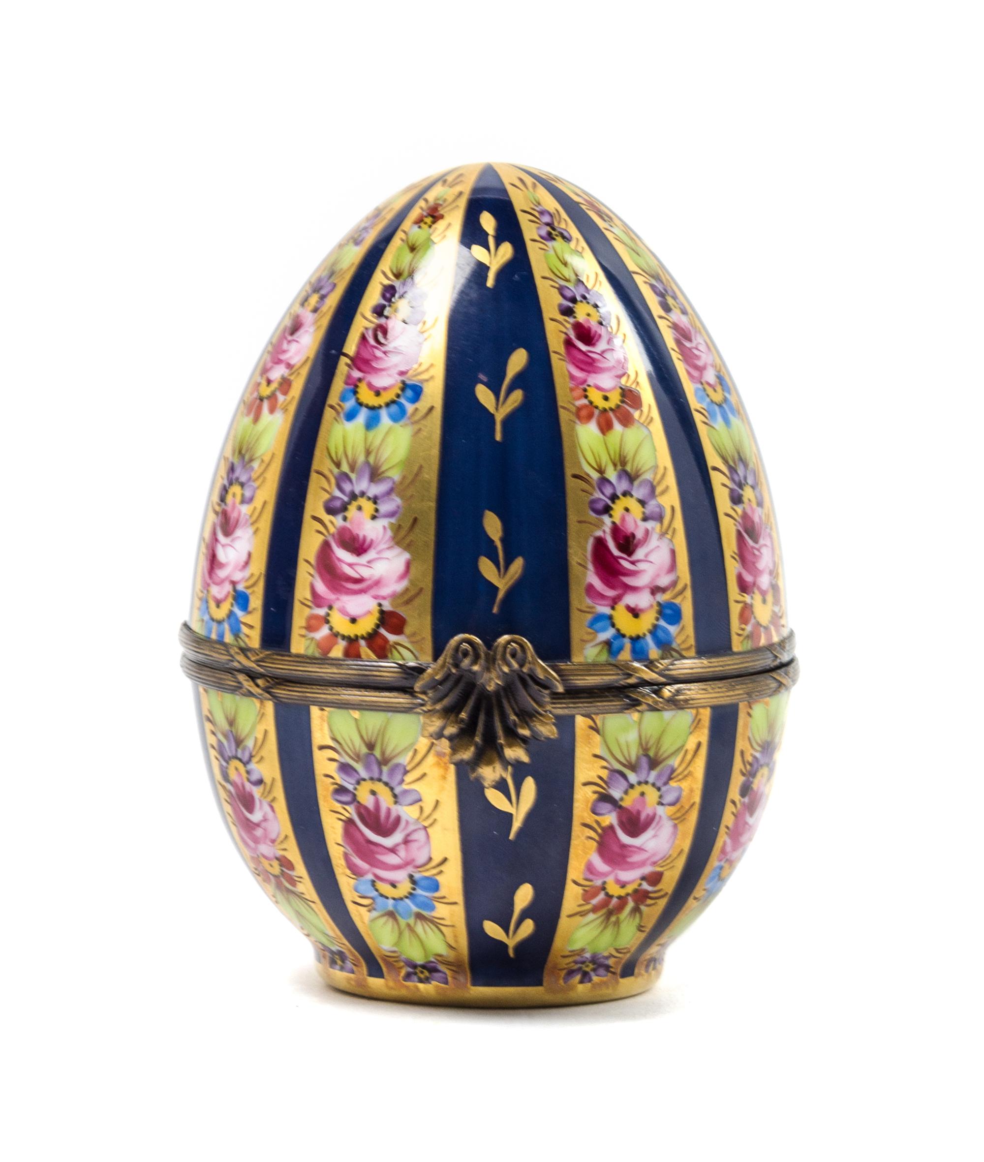A Limoges Hand Painted Porcelain Egg-Form Box Height 4 3/4 inches. — 20TH CENTURY