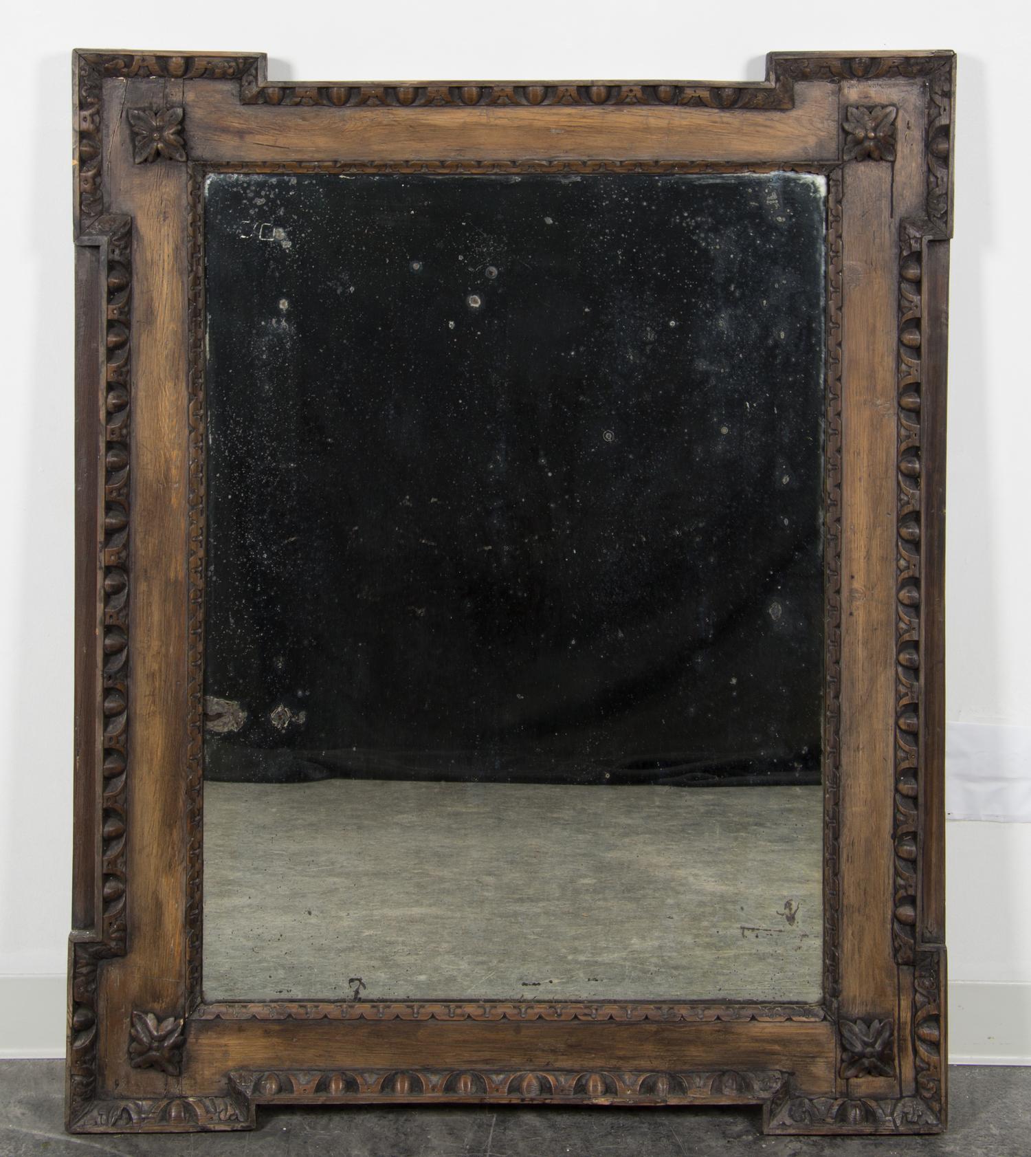 A Continental Carved Walnut Mirror Height 49 x width 39 3/4 inches. — 19TH CENTURY