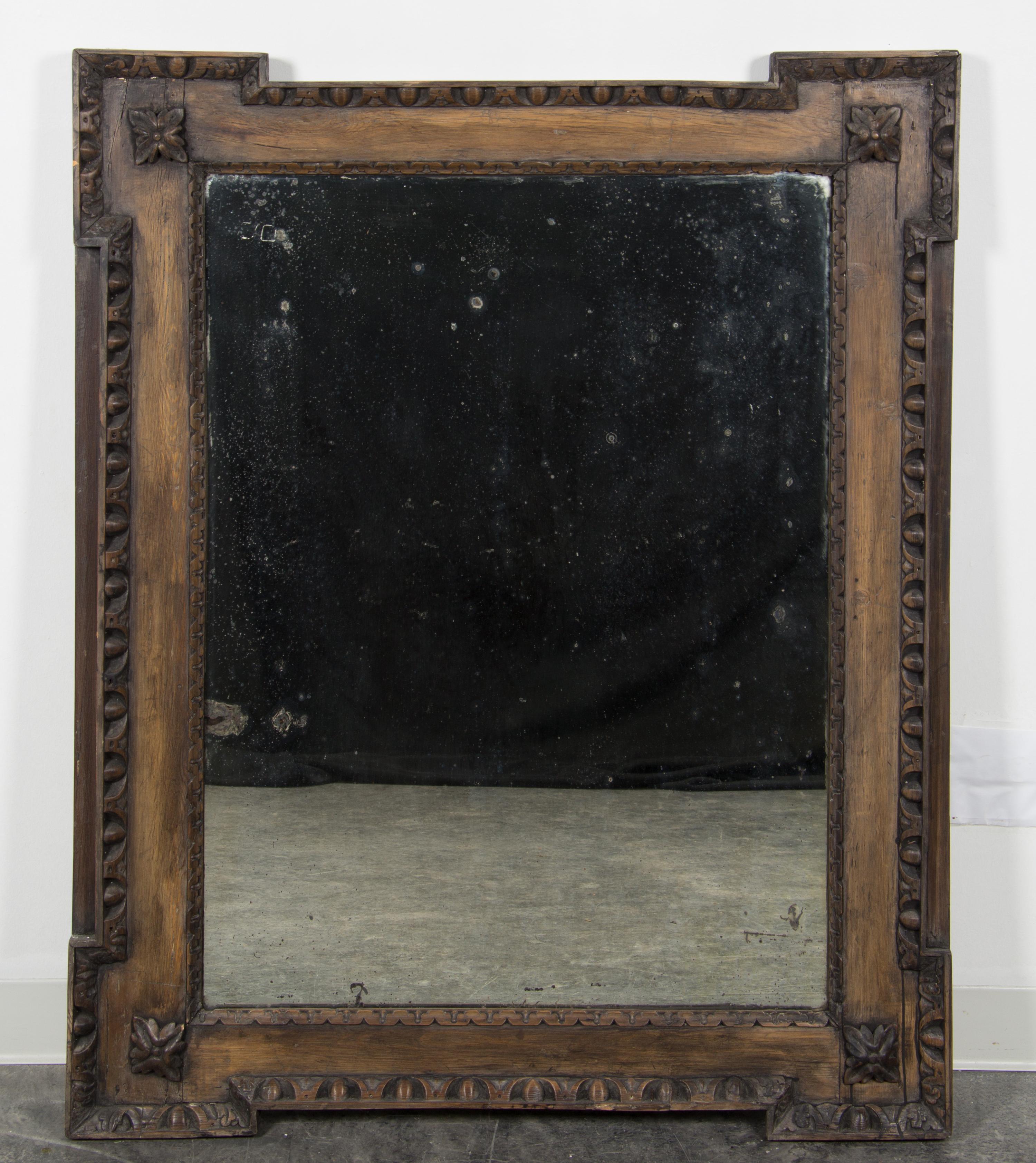 A Continental Carved Walnut Mirror Height 49 x width 39 3/4 inches. — 19TH CENTURY