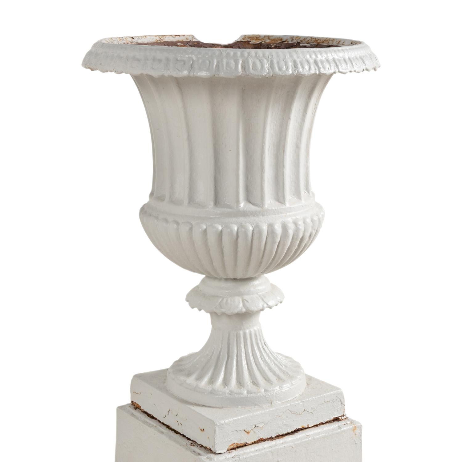 A Set of Three White Painted Iron Garden Urns