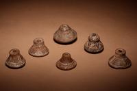 A Group of Six Quimbaya Terracotta Spindle Whorls
