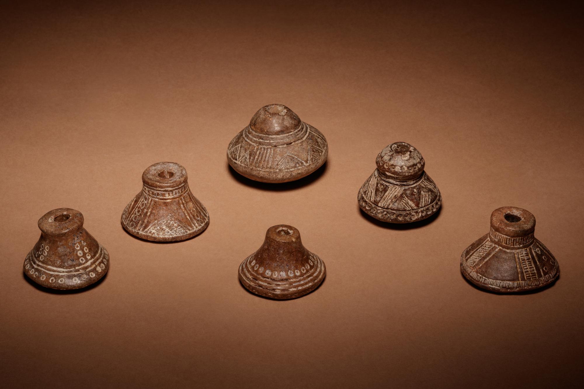 A Group of Six Quimbaya Terracotta Spindle Whorls
