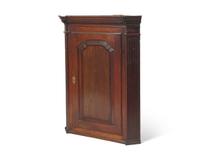 A George III Carved Oak Hanging Corner Cupboard