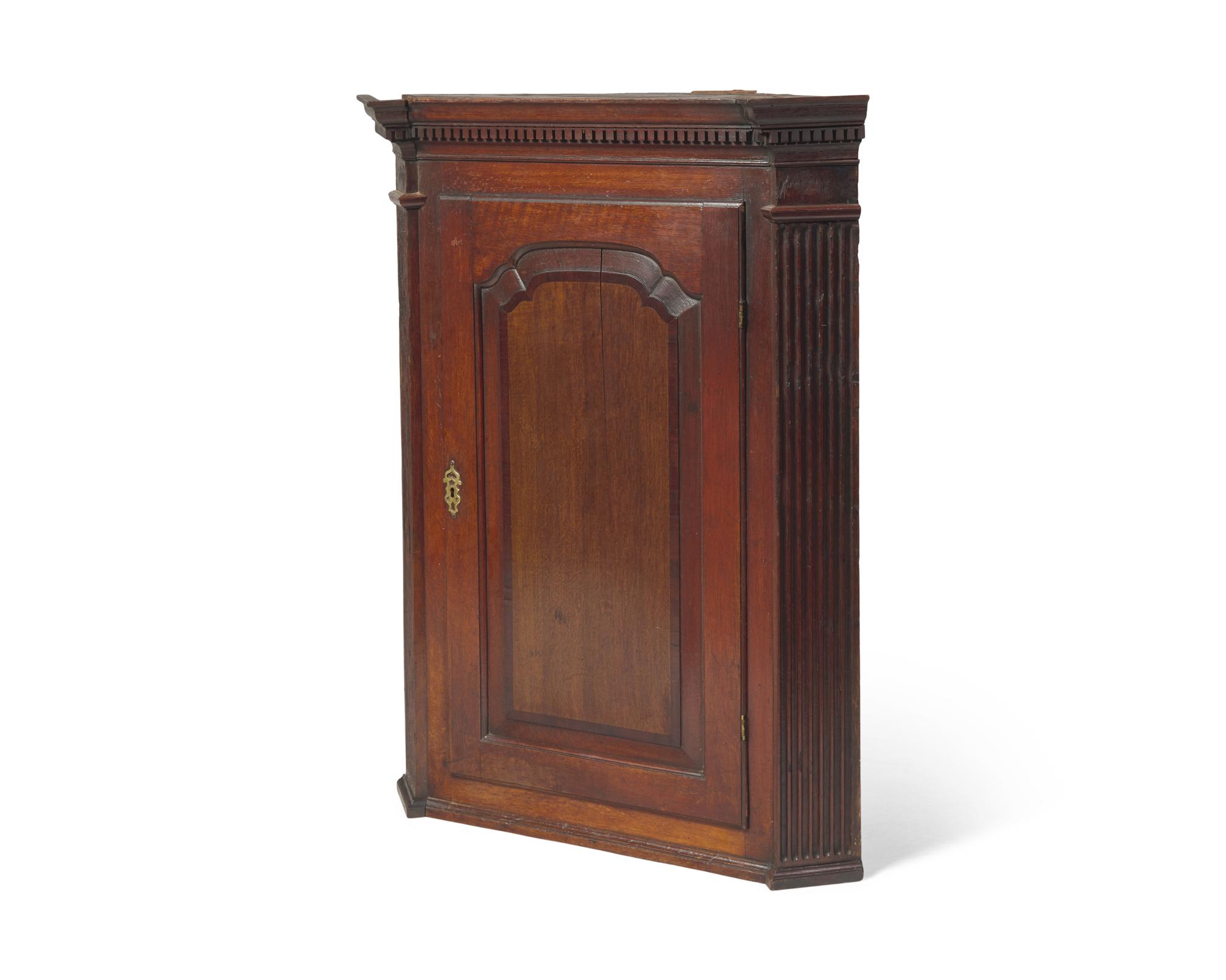 A George III Carved Oak Hanging Corner Cupboard