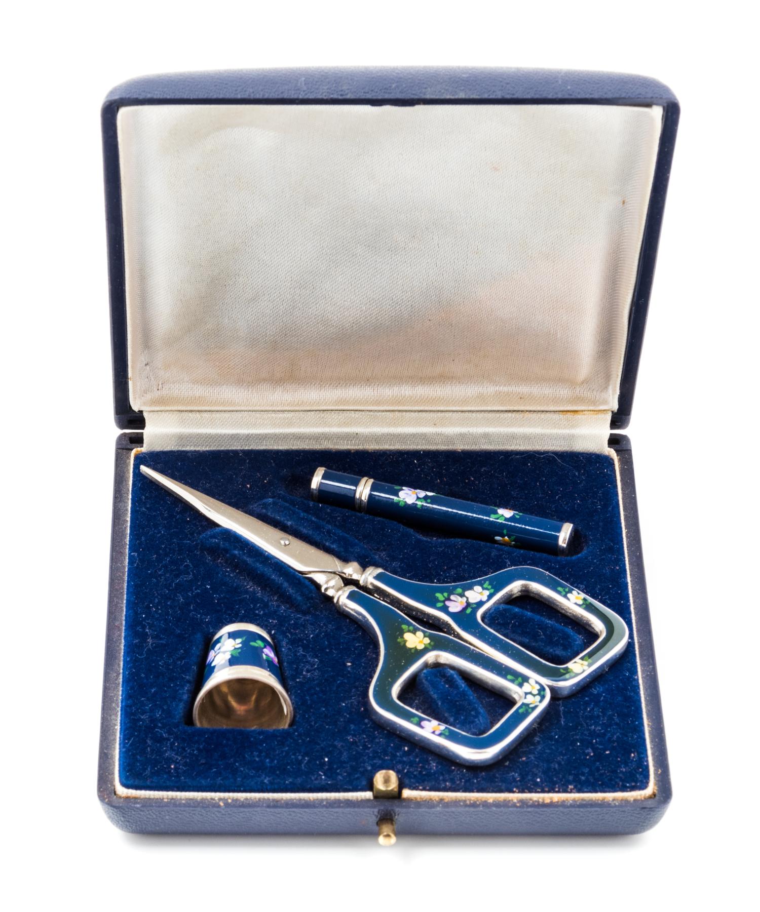 A German Silver and Enamel Three-Piece Sewing Kit, , comprising scissors, a thimble and a needle case, each having a dark blue enamel g