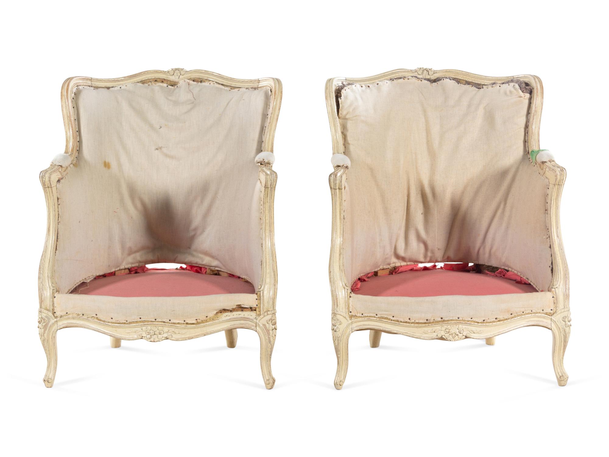 A Pair of Louis XV Carved and White-Painted Low Bergères