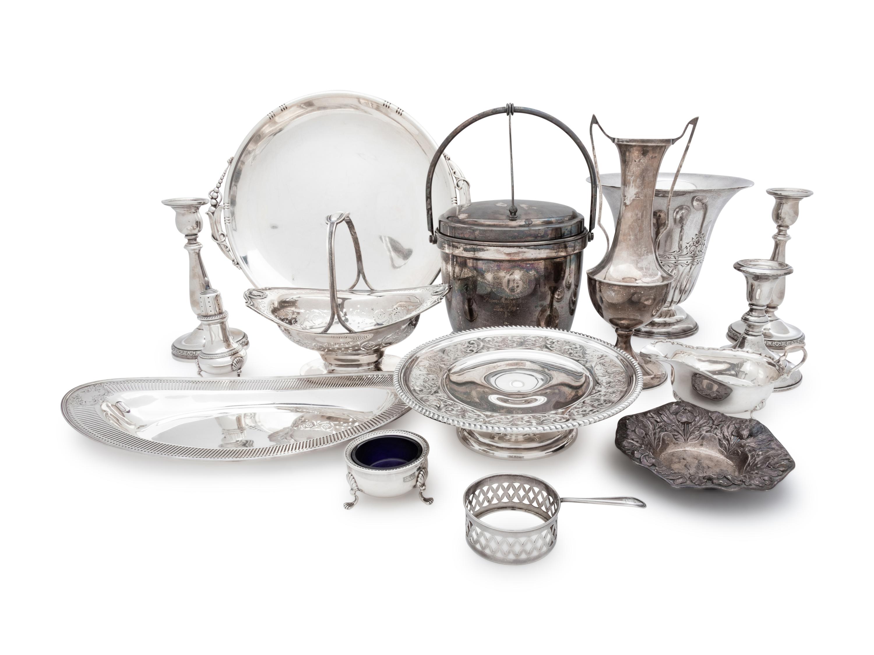 comprising a J. Wagner & Sons serving dish, Birks Silver Co. tazza, Tuttle Silversmiths vase, Dingwall sugar basket, Gorham nut dish, English bread dish and sauce boat, caster, salt cellar, three weighted candlesticks and a weighted vase, together with a silver-plate ice bucket. 15 items total.