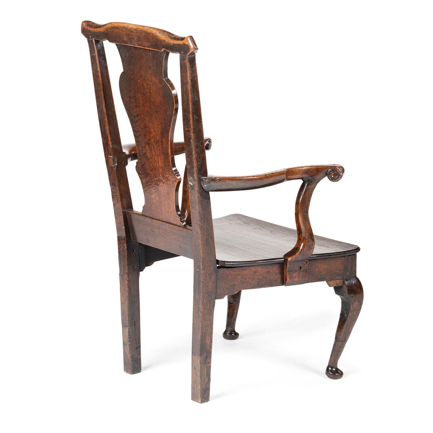 A Queen Anne Volute Carved Oak Open Armchair
