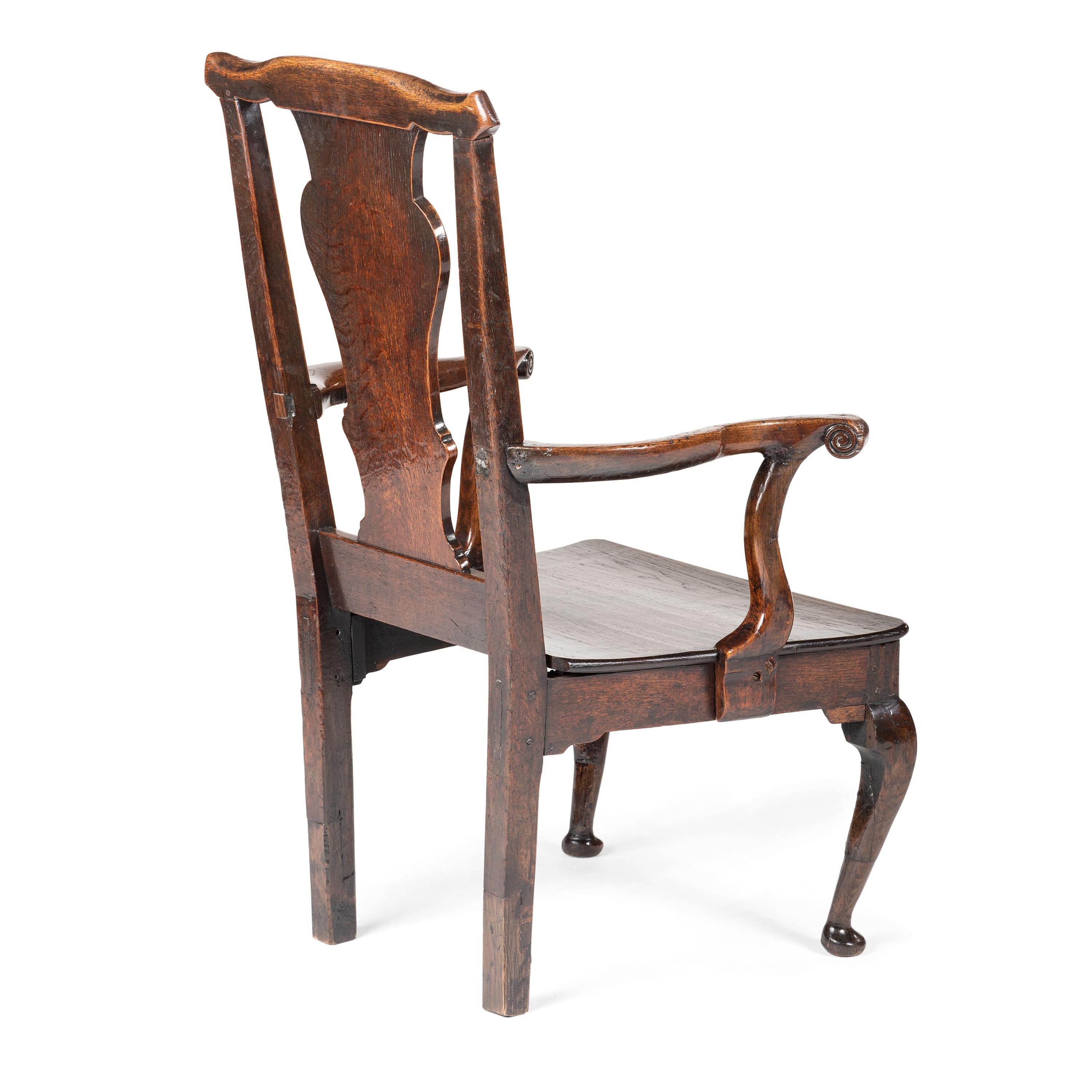 A Queen Anne Volute Carved Oak Open Armchair