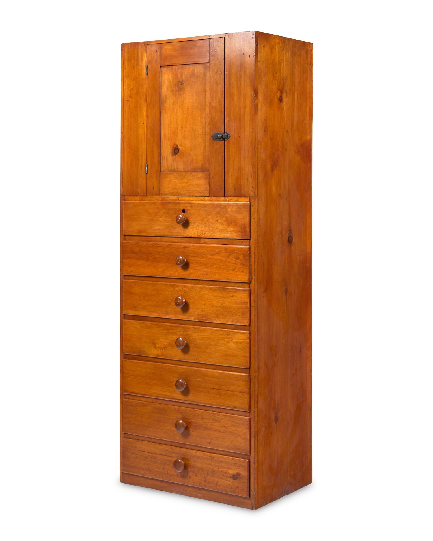 A Shaker Pine Cupboard Over Seven Drawers