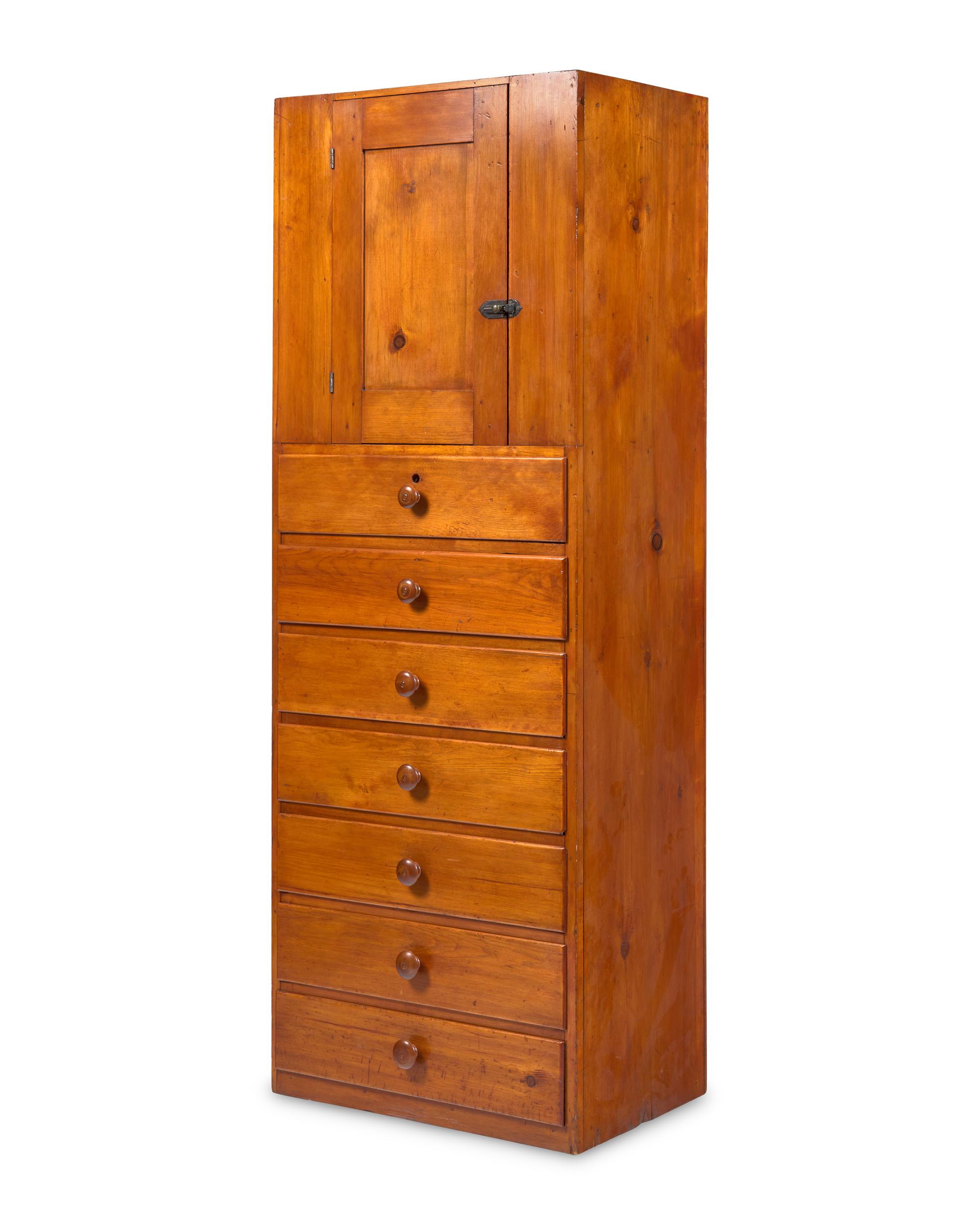 A Shaker Pine Cupboard Over Seven Drawers