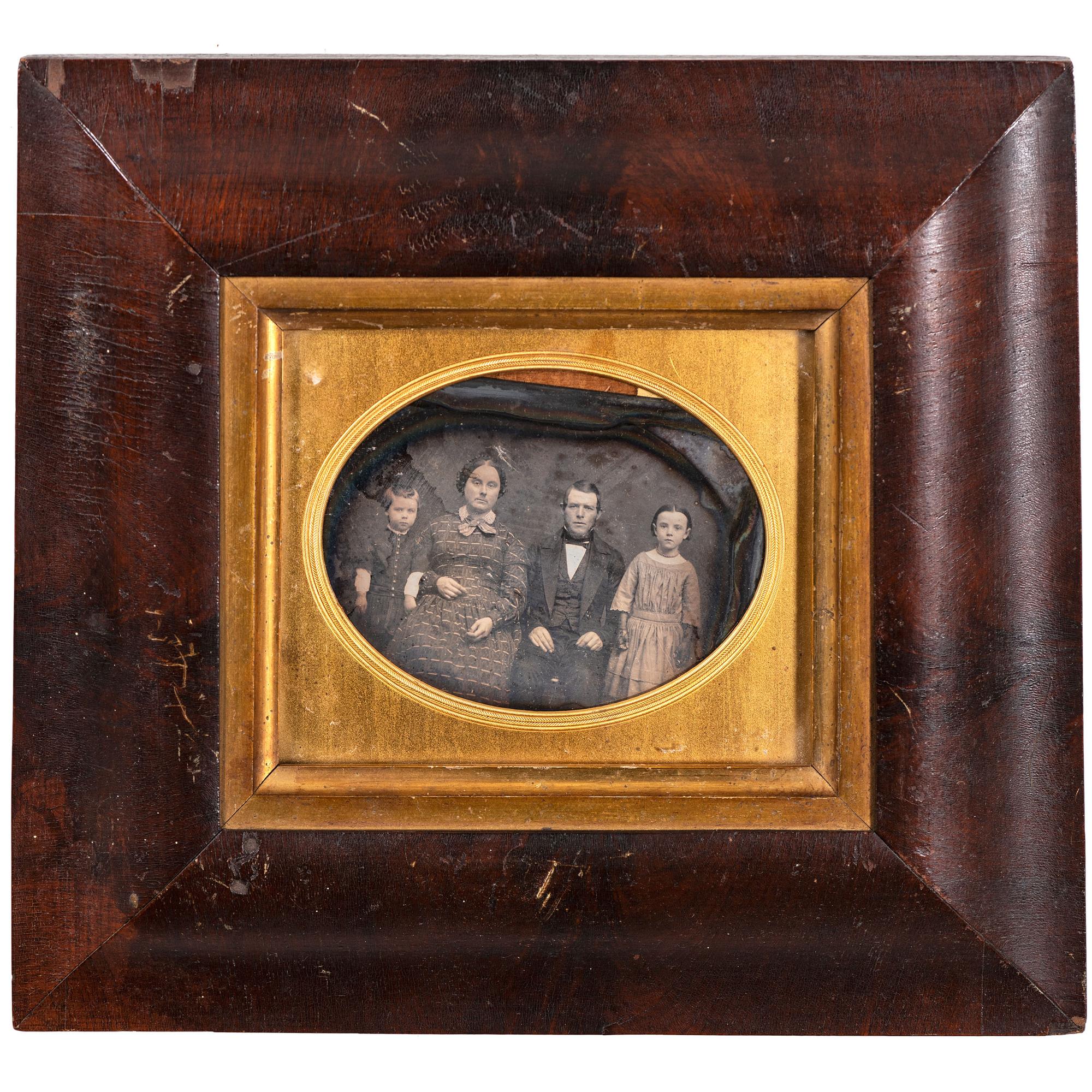 [EARLY PHOTOGRAPHY - PORTRAITURE]. A pair of half plate daguerreotype portraits of families housed in wooden wall frames, comprising: