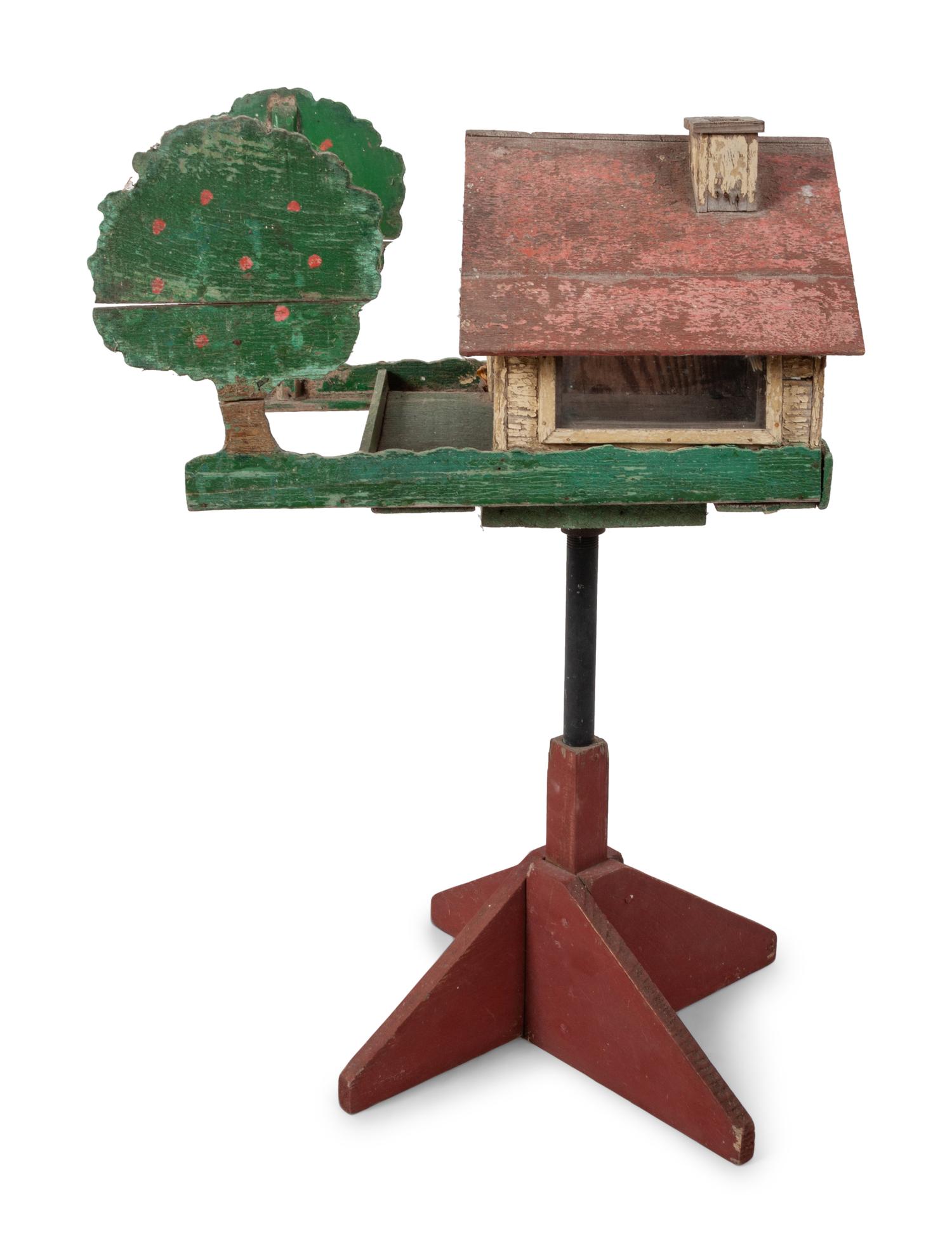 A Carved and Painted Wood Directional Tree and House Bird Feeder