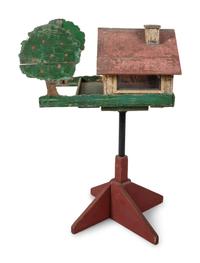 A Carved and Painted Wood Directional Tree and House Bird Feeder