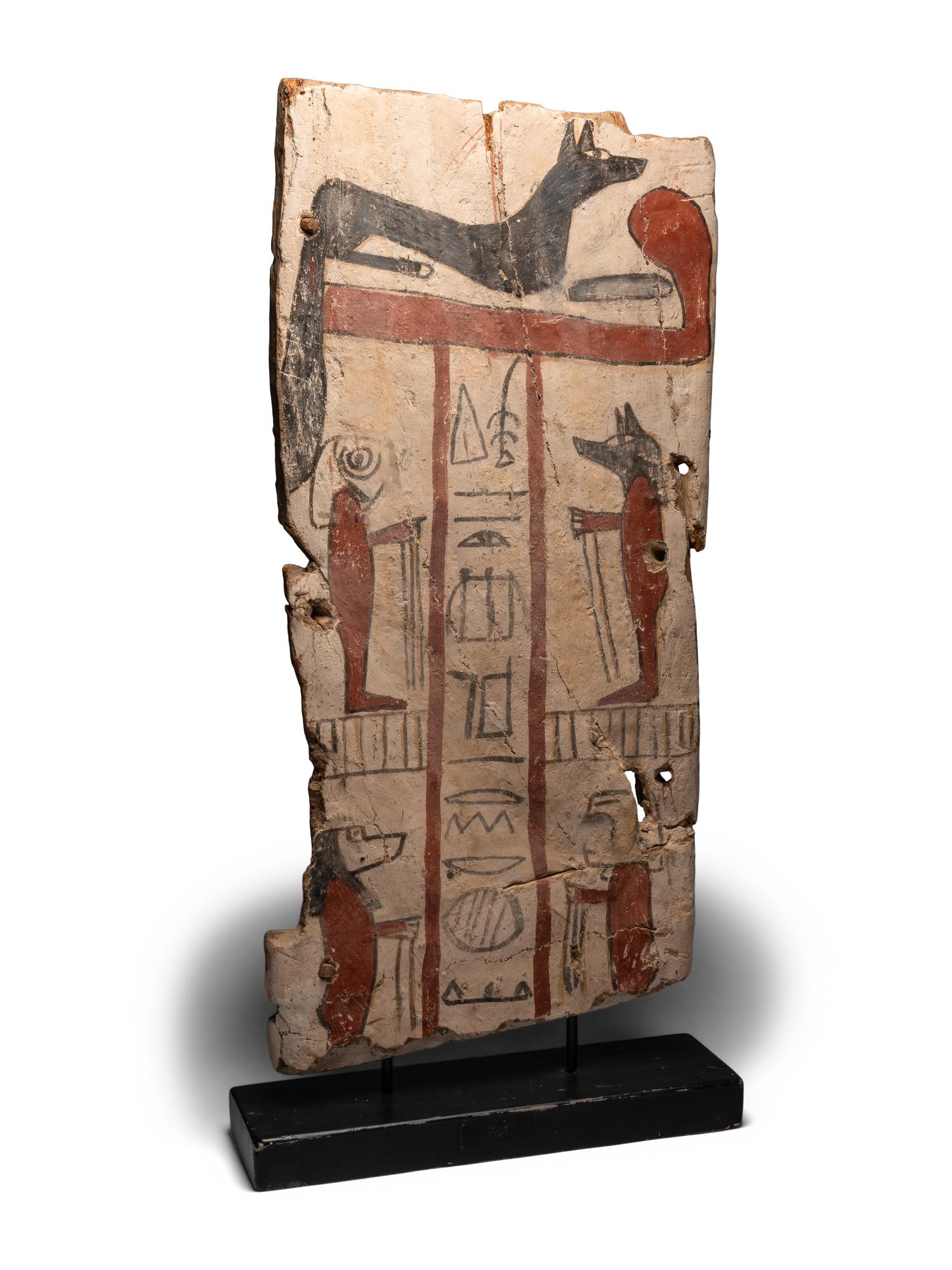 An Egyptian Painted Wood Sarcophagus Panel with Anubis