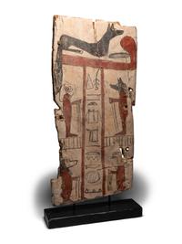 An Egyptian Painted Wood Sarcophagus Panel with Anubis