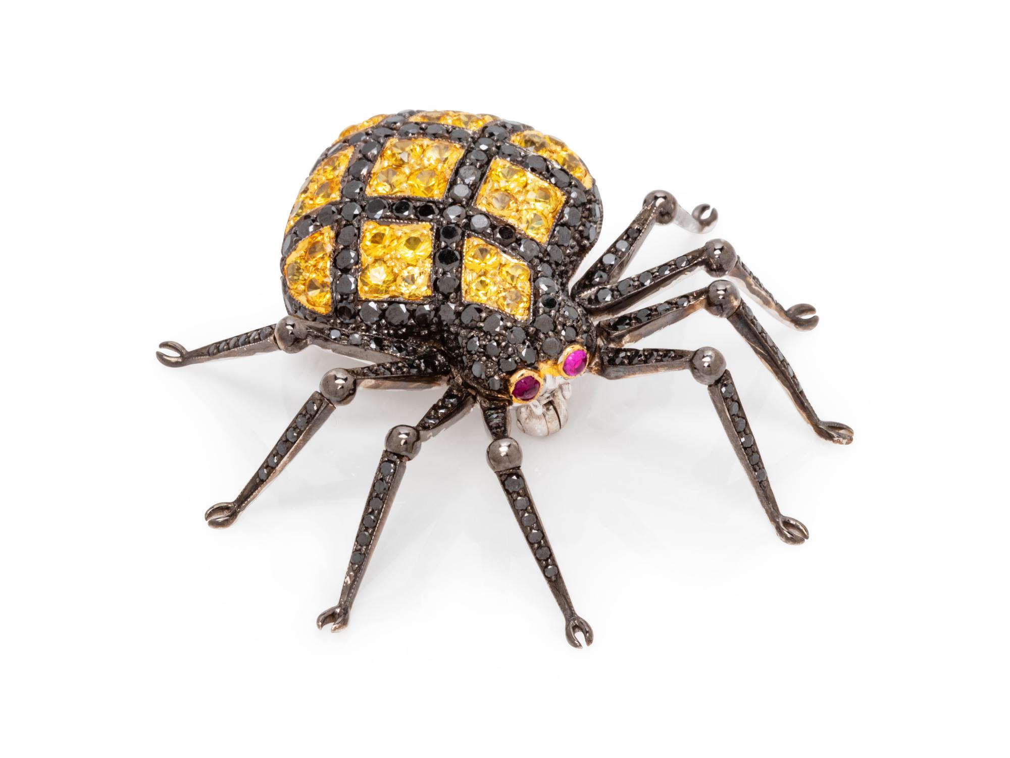An 18 Karat White Gold, Black Diamond and Yellow Sapphire Spider Brooch,