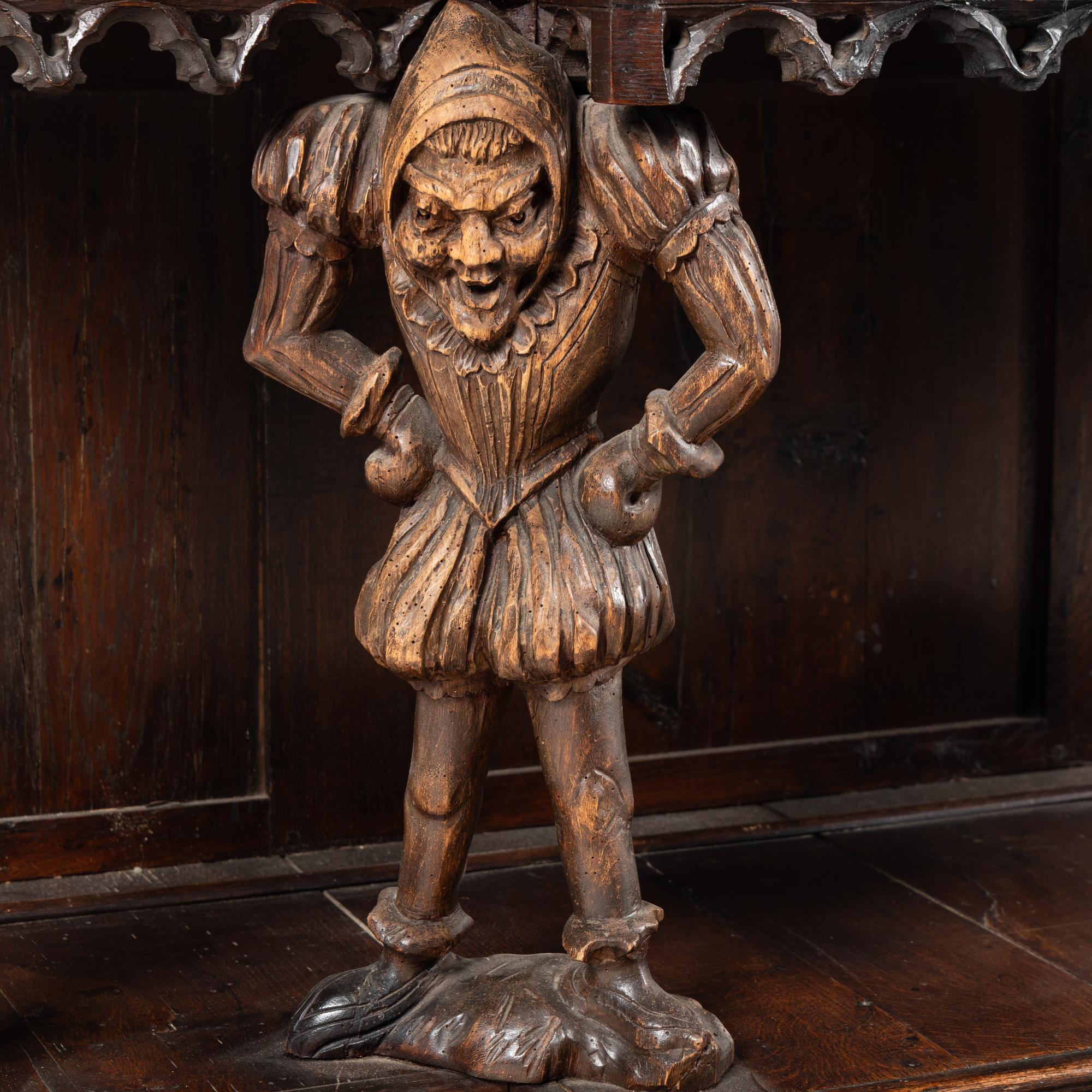 A Gothic Revival Carved Oak Court Cupboard