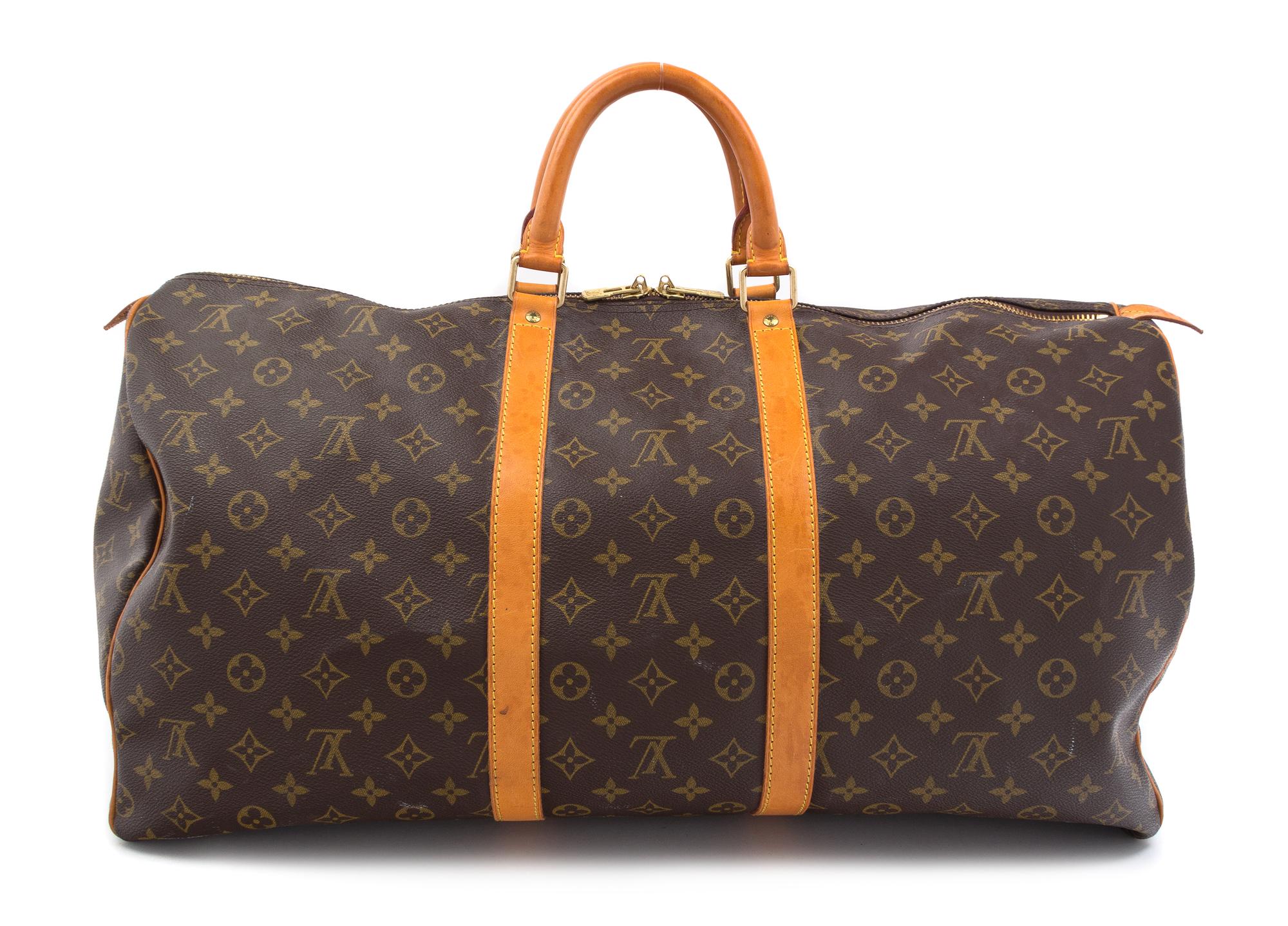A Louis Vuitton Monogram Canvas Duffle Bag, 22" x 13" x 10".