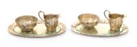 A Pair of German Silver-Gilt Creamer and Sugar Sets, , comprising a creamer, sugar and underplate, each having floral and foliate repou