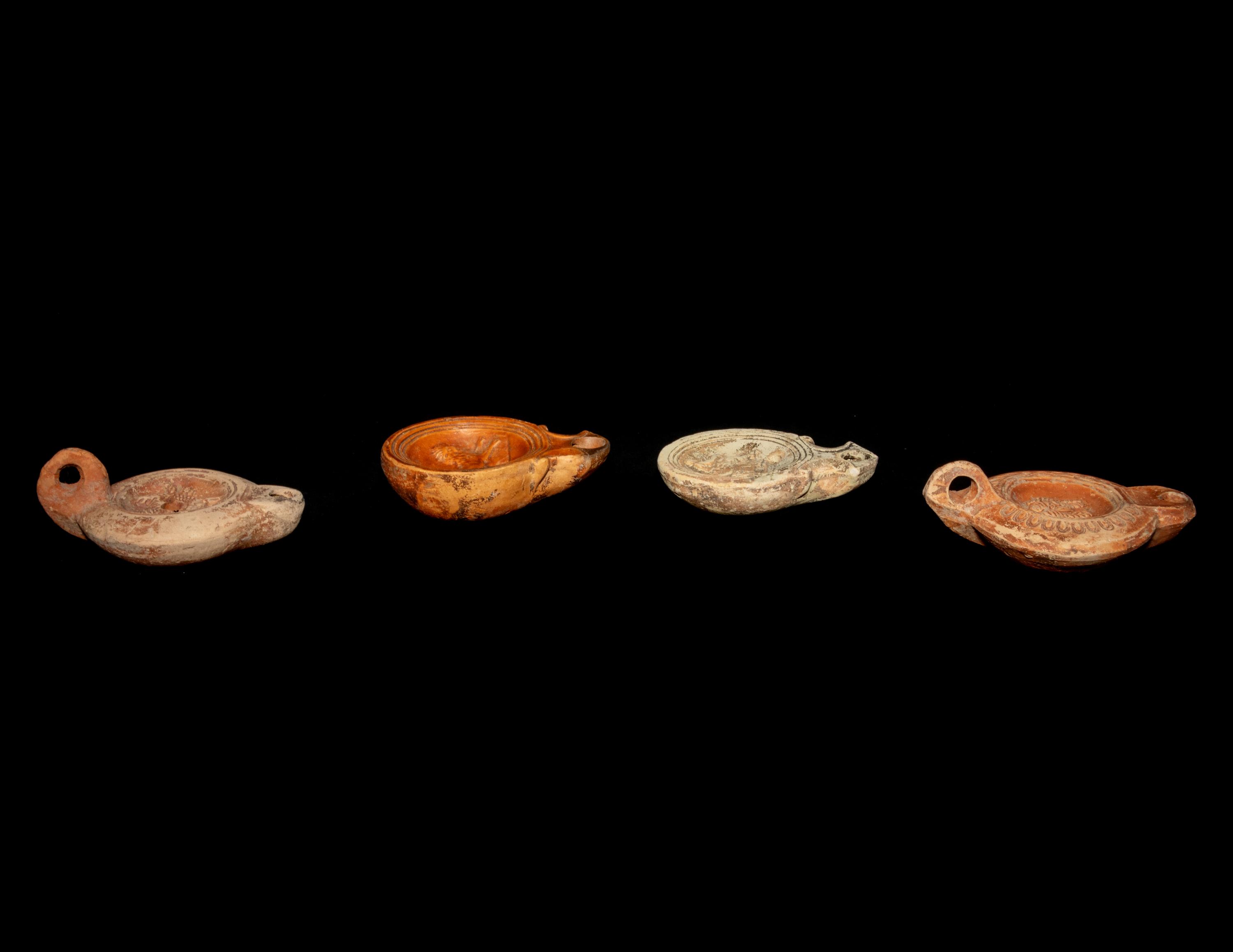 Four Roman Molded Terra Cotta Oil Lamps
