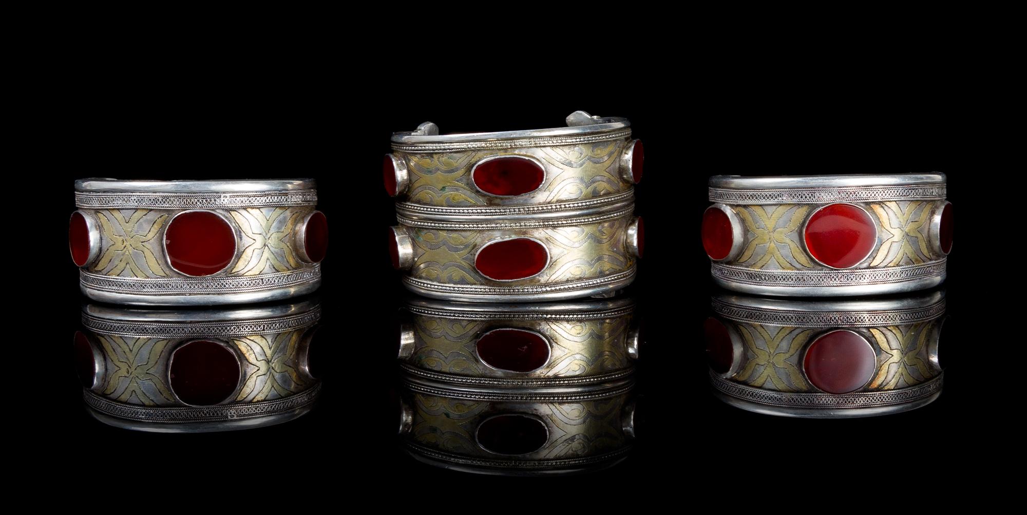 A Group of Three Carnelian Inset and Silvered Metal Bracelets Width 2 3/4 inches.