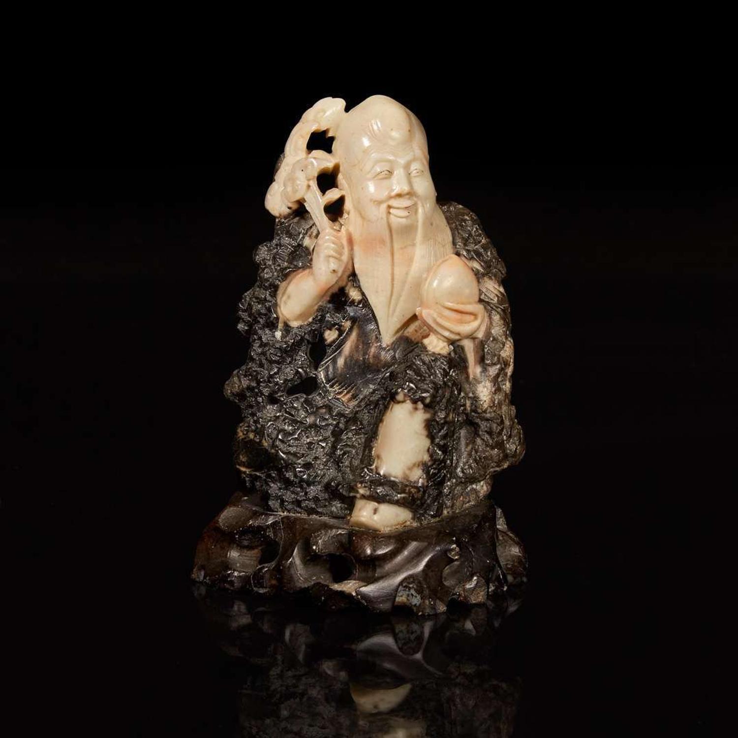 A Chinese carved beige and dark brown soapstone figure of Shoulao 棕灰壽山石雕壽老 19th/20th century ???????