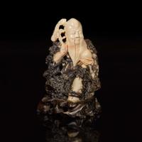 A Chinese carved beige and dark brown soapstone figure of Shoulao 棕灰壽山石雕壽老 19th/20th century ???????