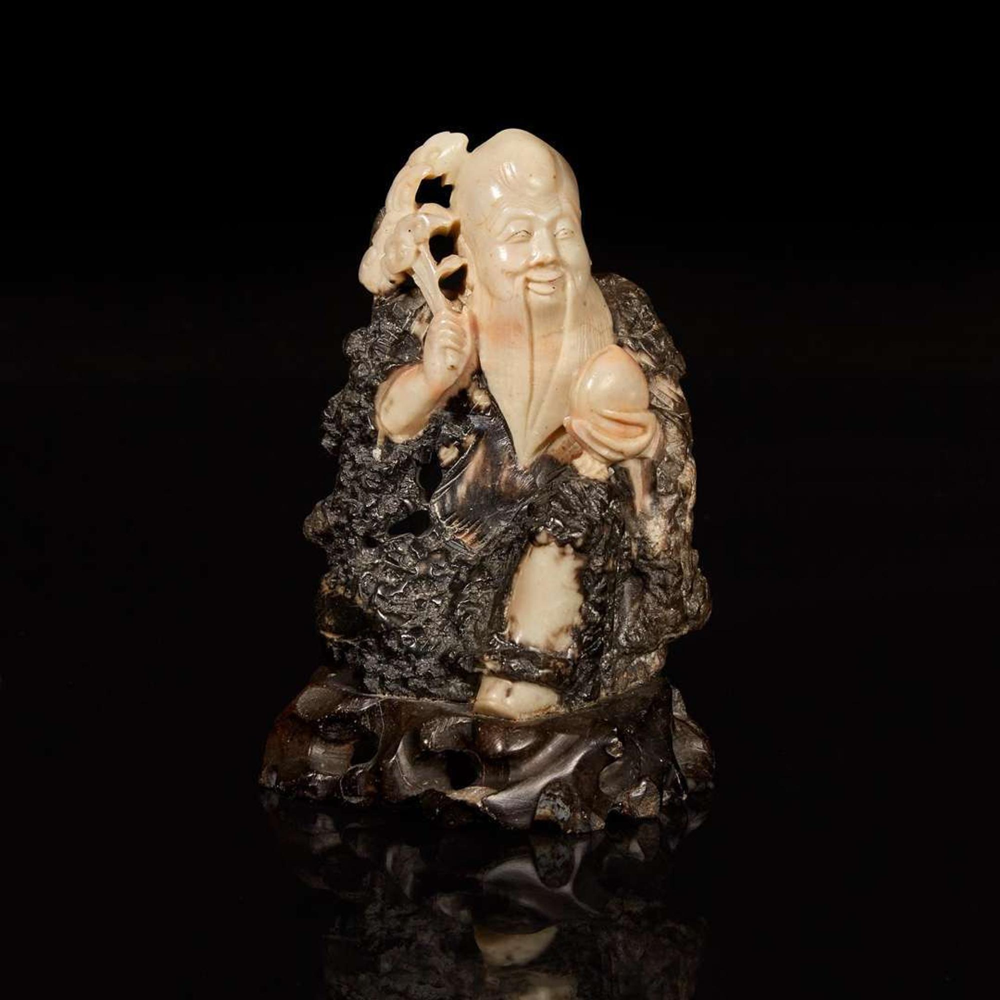 A Chinese carved beige and dark brown soapstone figure of Shoulao 棕灰壽山石雕壽老 19th/20th century ???????