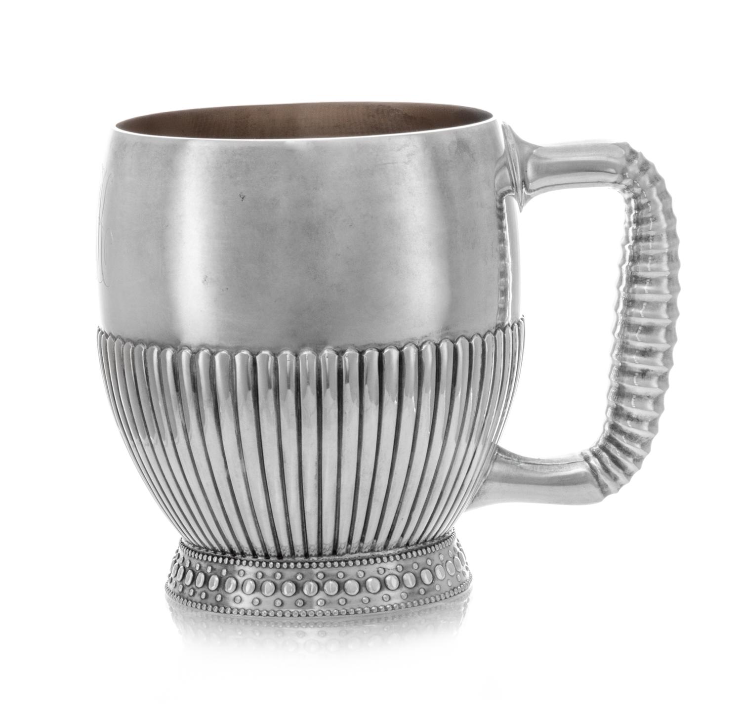 An American Silver Children's Mug, Gorham Mfg. Co., Providence, RI, 1884, having a fluted bowl and handle and raised on a flared foot w