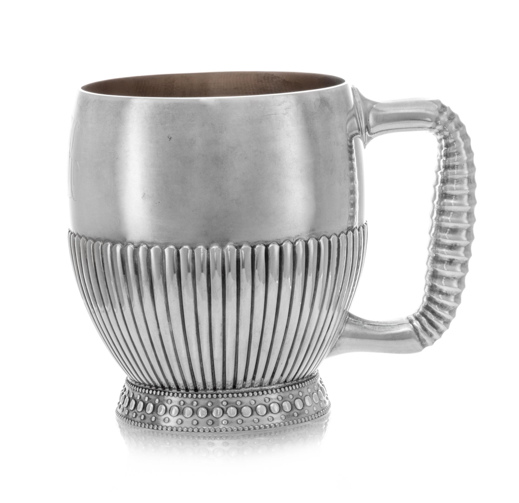 An American Silver Children's Mug, Gorham Mfg. Co., Providence, RI, 1884, having a fluted bowl and handle and raised on a flared foot w