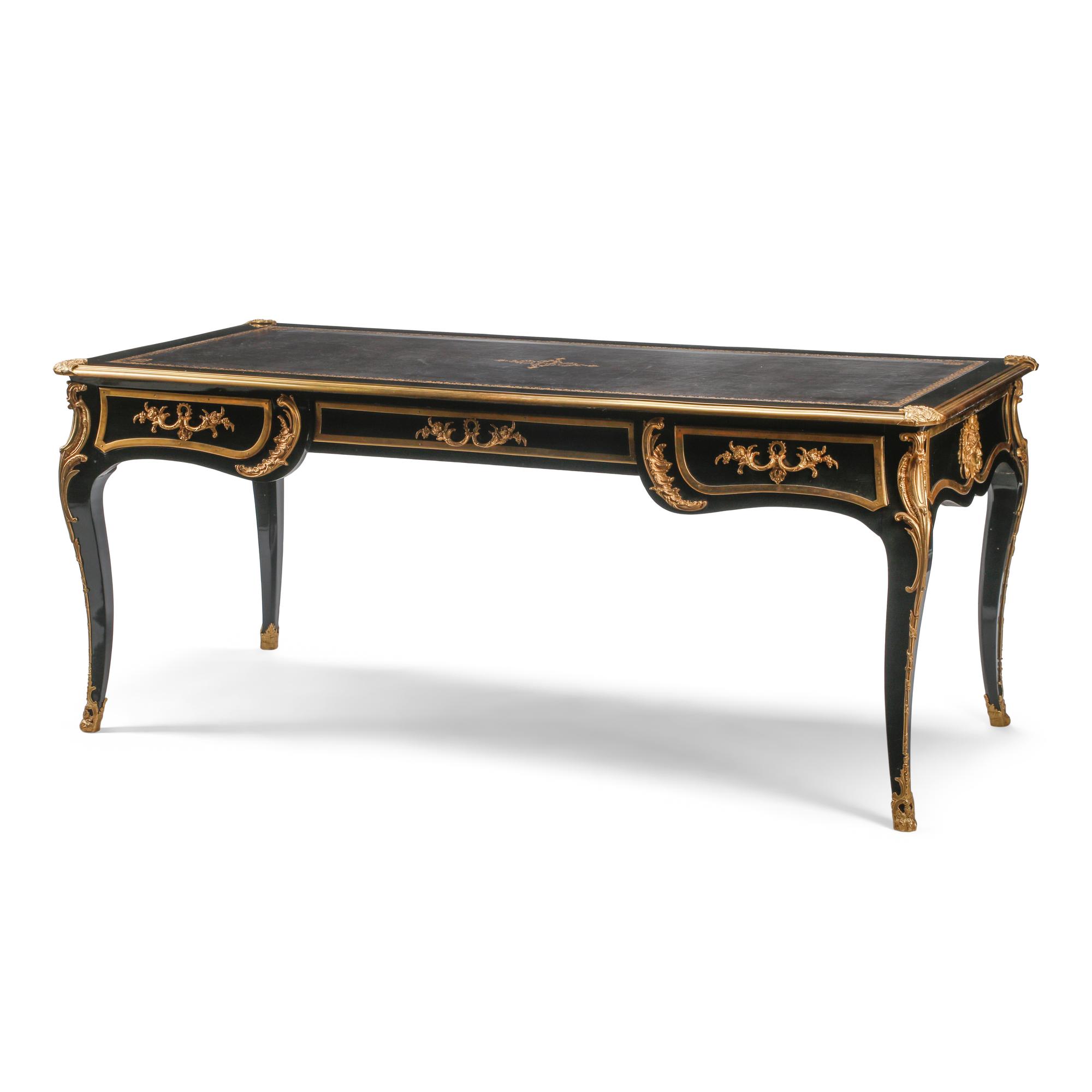 A Louis XV Style Ebonized and Gilt Bronze Mounted Bureau Plat