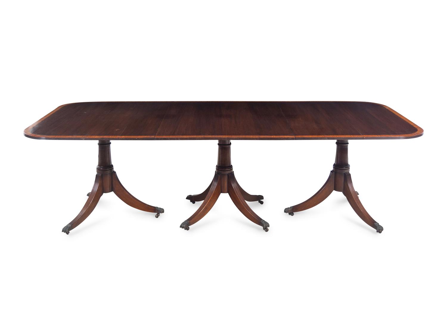 A Regency Style Satinwood Banded Mahogany Triple-Pedestal Dining Table